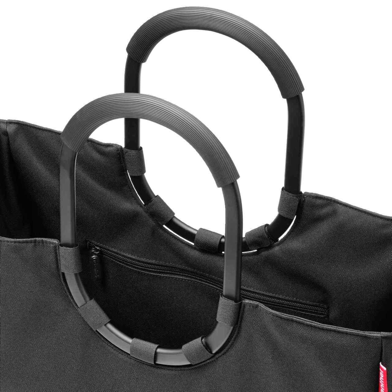 Close-up van een zwarte Loopshopper met stevige, ovale handvatten en een vak met ritssluiting, gezien van bovenaf.