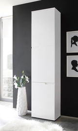 Weißer, hoher Schrank vor schwarzer Wand, seitliche Perspektive