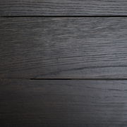 Draufsicht auf eine dunkle Holzoberfläche eines Esstisches mit sichtbarer Maserung.