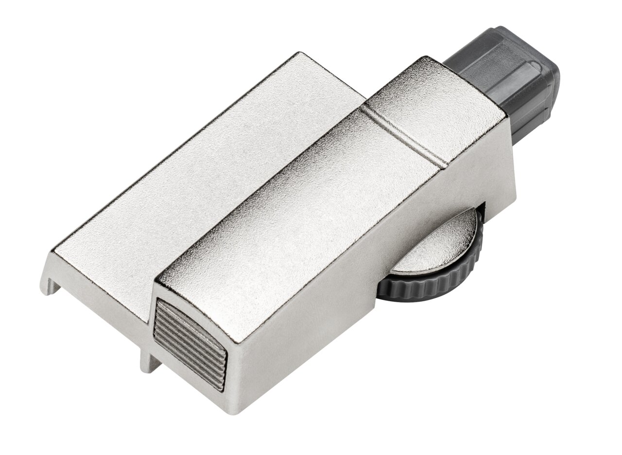 Metallischer Dämpfer in schräger Draufsicht mit geriffeltem Einstellrad.