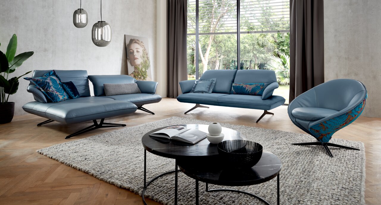 Koinor Sessel IMPULS Moderner blauer Sessel in einem stilvoll eingerichteten Wohnzimmer, seitliche Perspektive.