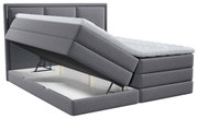 Grijs boxspringbed met opklapbaar matras en zichtbare opbergruimte, zijaanzicht