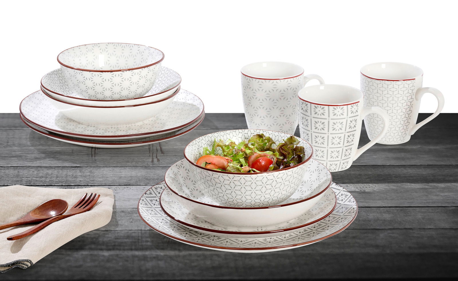 Kombiservice 30-teilig mit elegantem Muster, bestehend aus Tellern, Schalen und Tassen, auf einem Holztisch von schräg oben fotografiert.