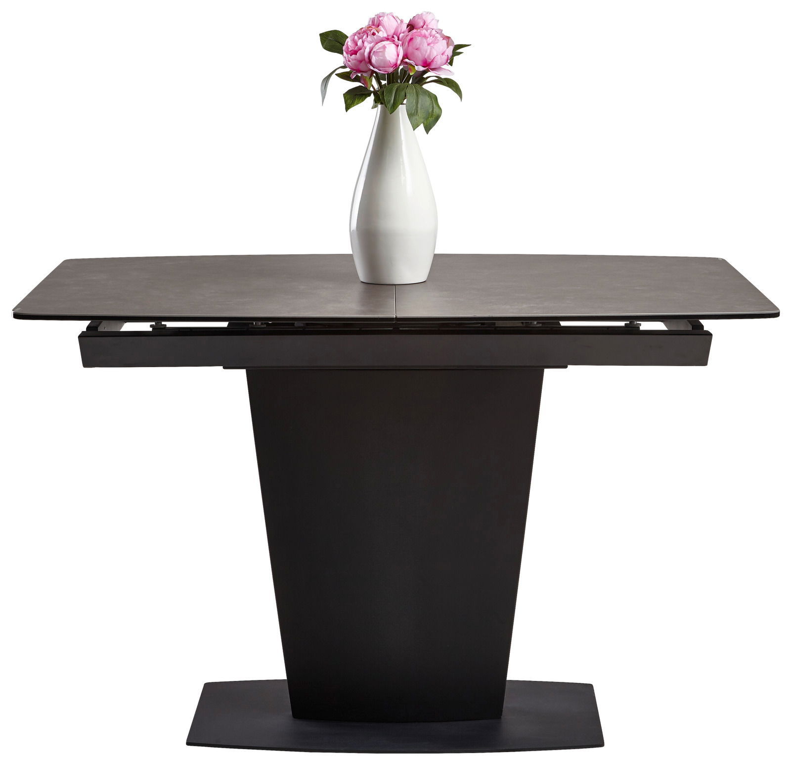 Moderner Esstisch mit dunklem Sockel und ausziehbarer Tischplatte, frontal betrachtet, dekoriert mit einer weißen Vase und rosa Blumen.