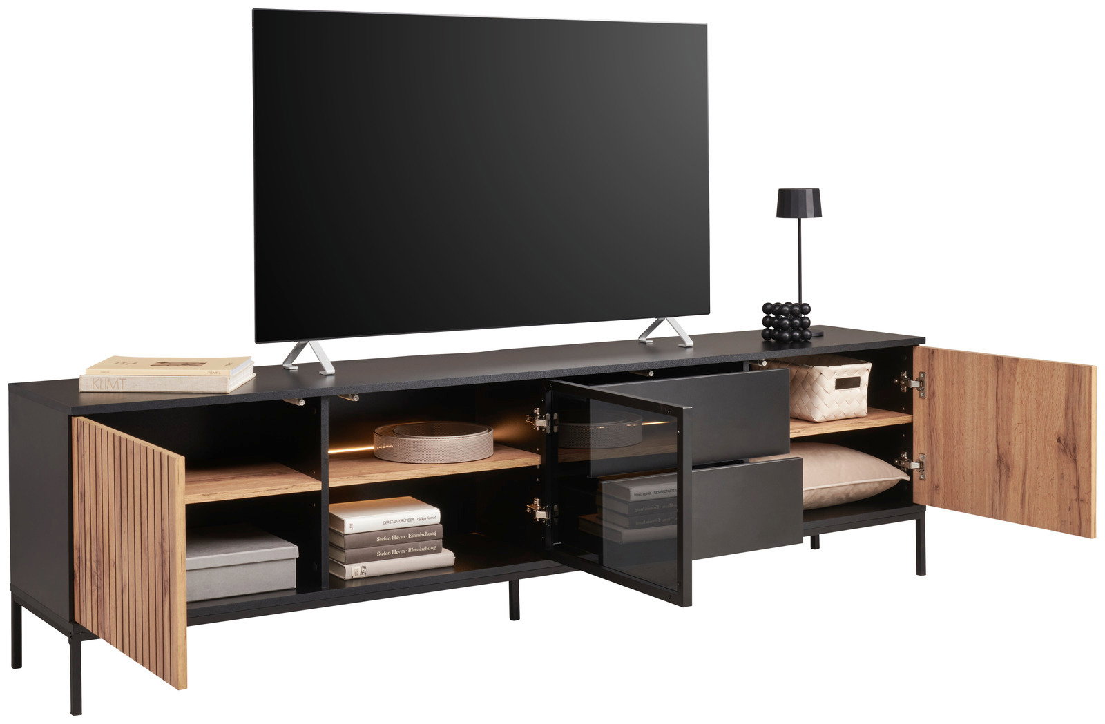 XL-TV-Lowboard in moderner Perspektive mit offenen Türen und Schubladen, zeigt Stauraum mit Büchern, Boxen und Dekorationen.