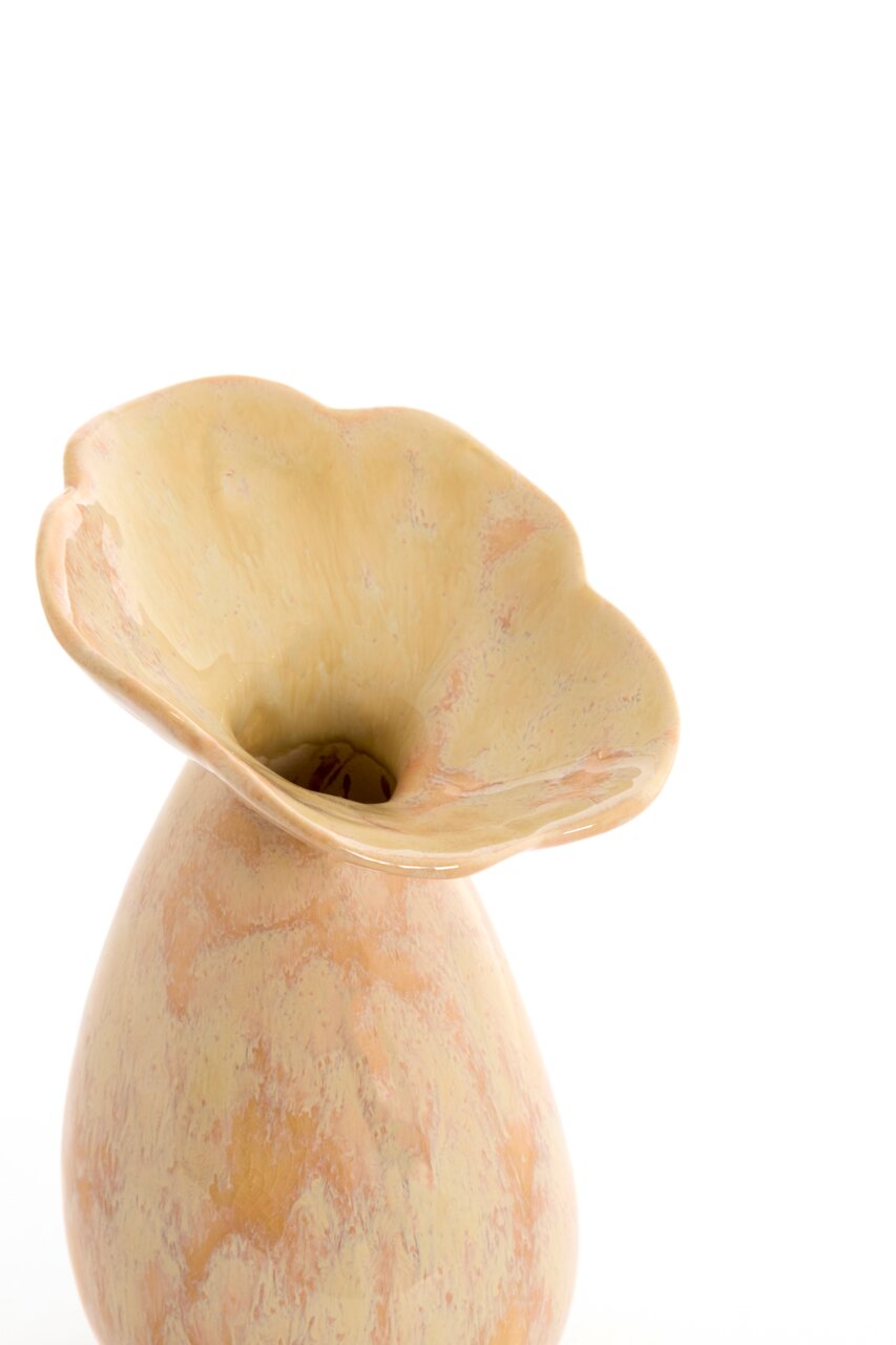 Nahaufnahme einer dekorativen Vase mit blumiger Öffnung und marmorierter Oberfläche in Beige- und Rosatönen, von oben betrachtet.
