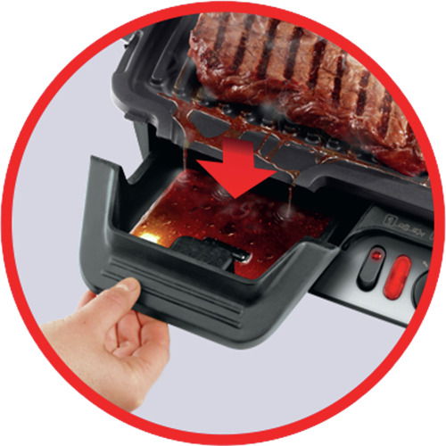 Nahaufnahme eines Kontaktgrills mit abtropfendem Fett in eine Auffangschale.