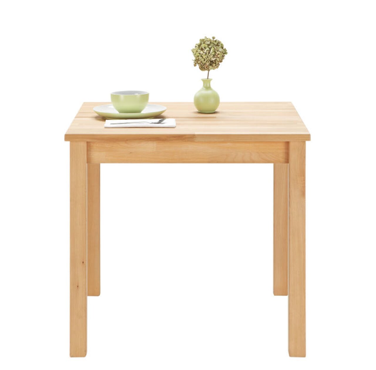 Esstisch aus Holz mit quadratischer Tischplatte, darauf eine grüne Vase mit Pflanze und ein grünes Geschirrset, frontale Perspektive