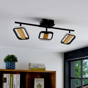 Moderne LED-Deckenleuchte mit drei verstellbaren Strahlern in Holz- und Metalloptik, von unten betrachtet.