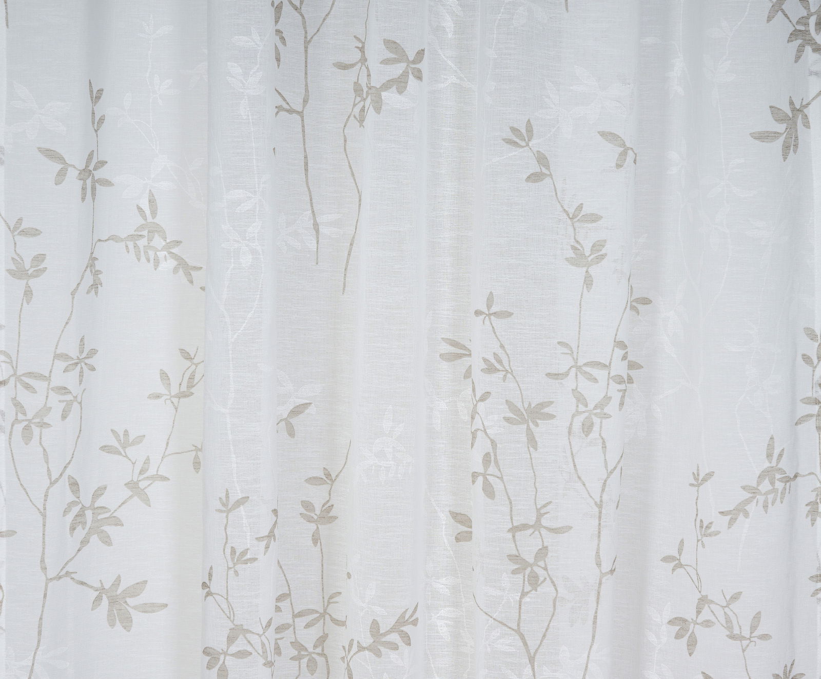 Nahaufnahme eines weißen Vorhangs mit zartem, floralen Muster in Beige, frontal betrachtet.