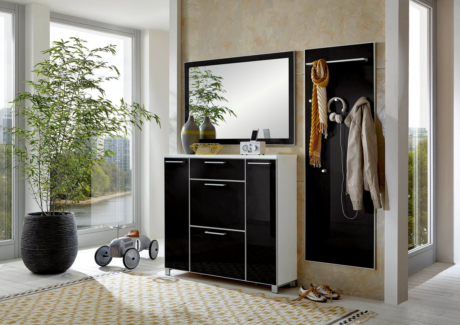 Modernes Garderoben-Set in schwarzem Hochglanz mit Spiegel und Hakenleiste, seitliche Perspektive.