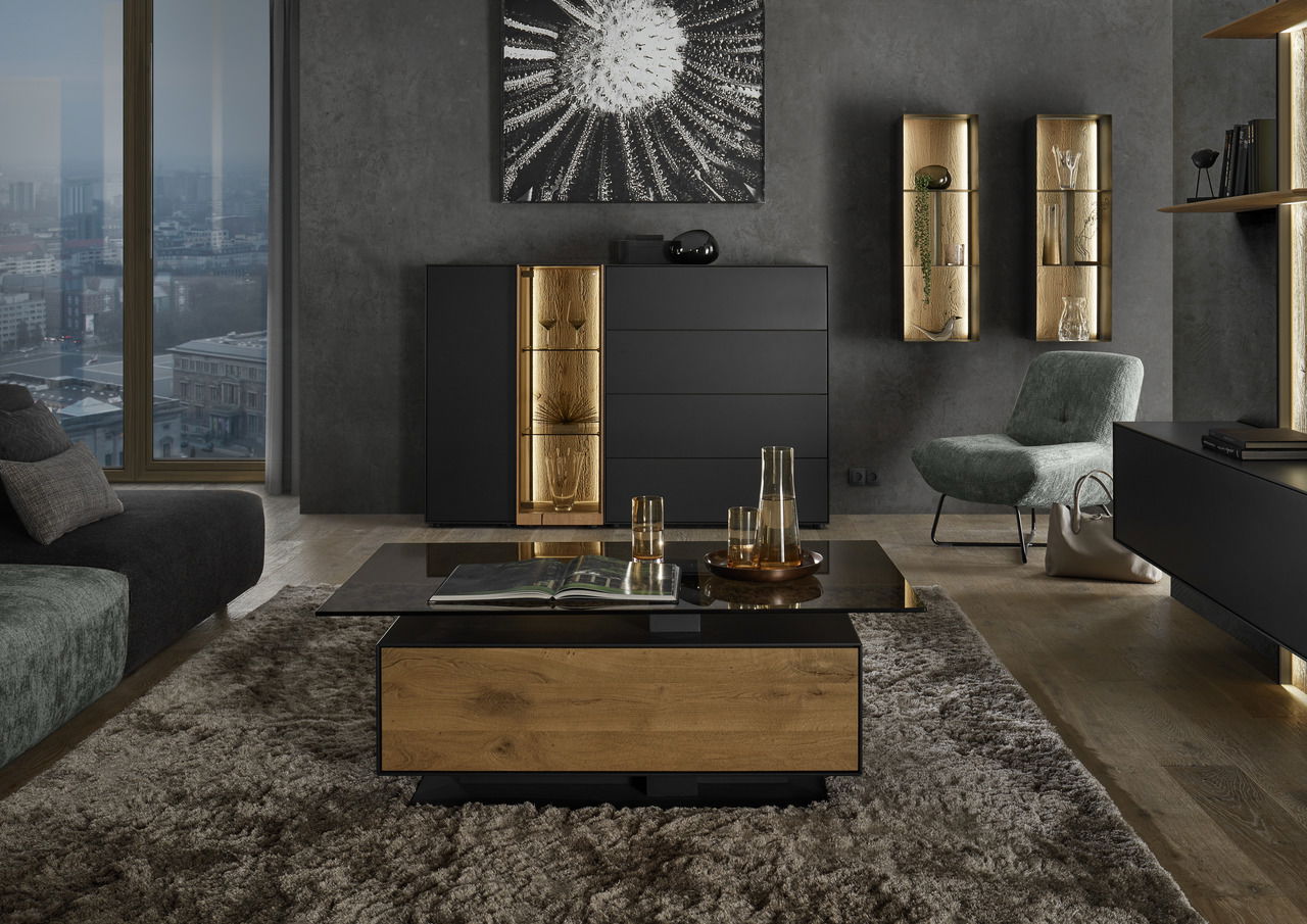 Moderne Wohnzimmeransicht mit Couchtisch aus Holz und Glas, Highboard mit LED-Beleuchtung und stilvollen Dekorationen, seitliche Perspektive.