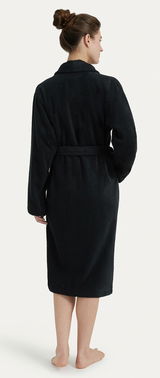 Rückansicht eines schwarzen Bademantels mit Schalkragen, getragen von einer Person mit hochgestecktem Haar.