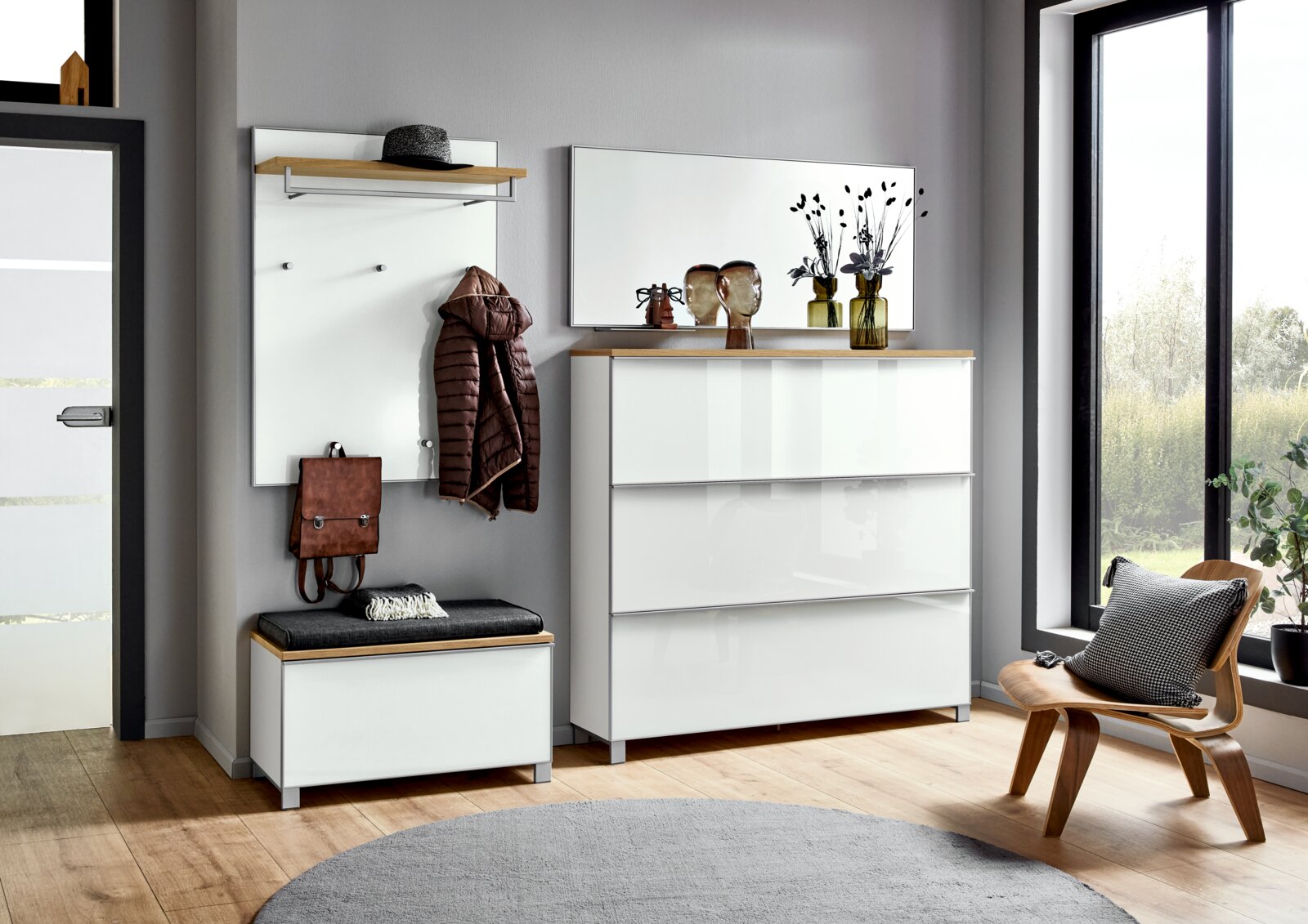 VOSS Garderoben-Set 6-tlg. VORTINA Modernes Flurmöbel-Set in Weiß mit Holz-Akzenten: Garderobenpaneel mit Ablage und Haken, Sitzbank mit Polster sowie Kommode mit Spiegel, gezeigt in frontaler Perspektive im Eingangsbereich.