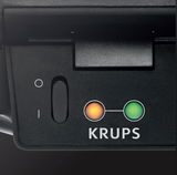 Nahaufnahme eines Krups Sandwich-Toasters mit Kontrollleuchten und Schalter auf der Vorderseite.
