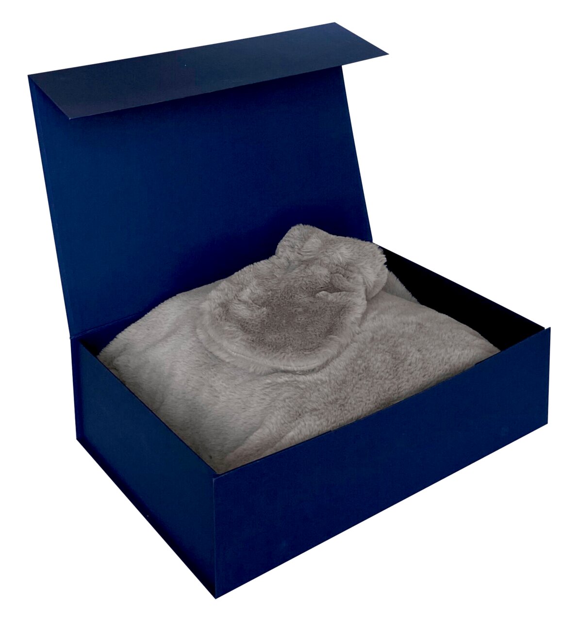 Geschenkset in einer offenen blauen Box mit weicher, grauer Decke, Ansicht von oben.