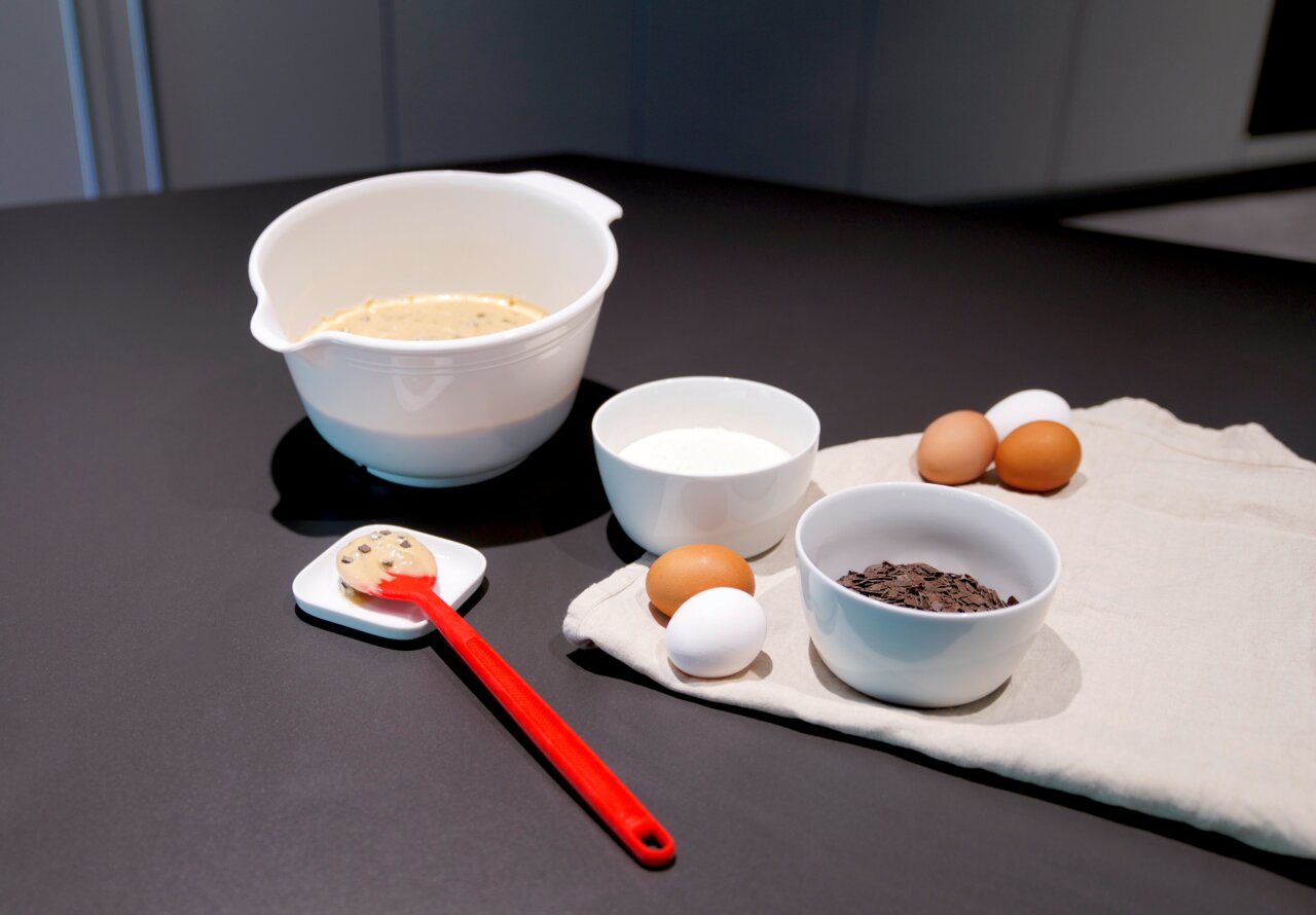 Dr. Oetker Sikikon-Kochlöffel Roter Silikon-Kochlöffel auf einem Tisch mit Backzutaten, seitliche Perspektive