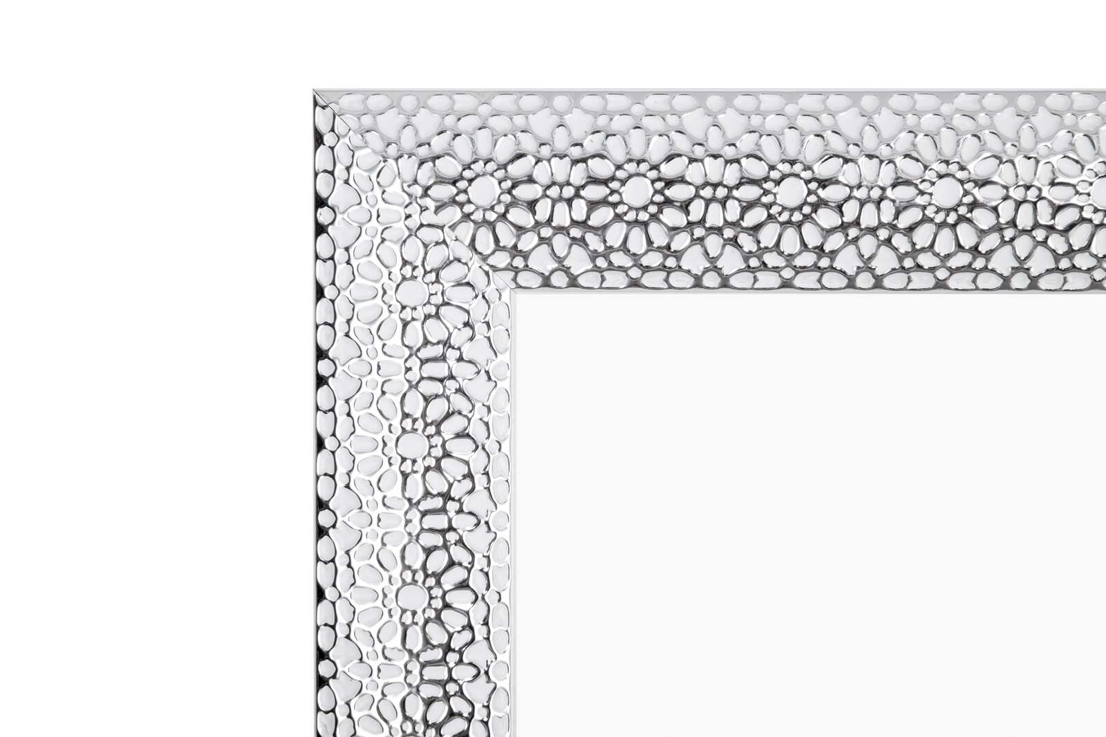 Nahaufnahme eines dekorativen Spiegelrahmens mit strukturierter, silberner Oberfläche, perspektivisch von der Ecke aus gesehen.