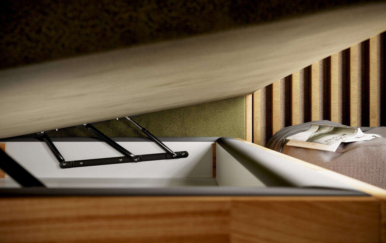 Close-up van een boxspringbed met geopende opberglade, waarop de opbergruimte en het hefmechanisme te zien zijn. Zijaanzicht.