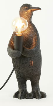 Pinguin-förmige Tischleuchte mit E14-Fassung, die eine Glühbirne hält. Frontalansicht.