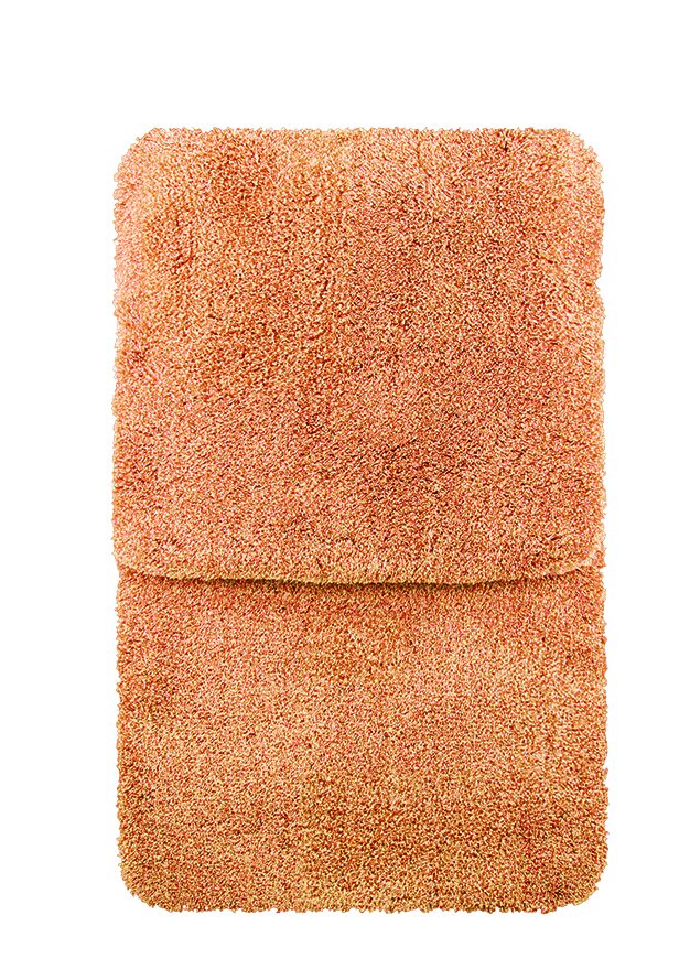 Tweedelige badmatten-set in warm oranje, gefotografeerd vanuit vogelperspectief.
