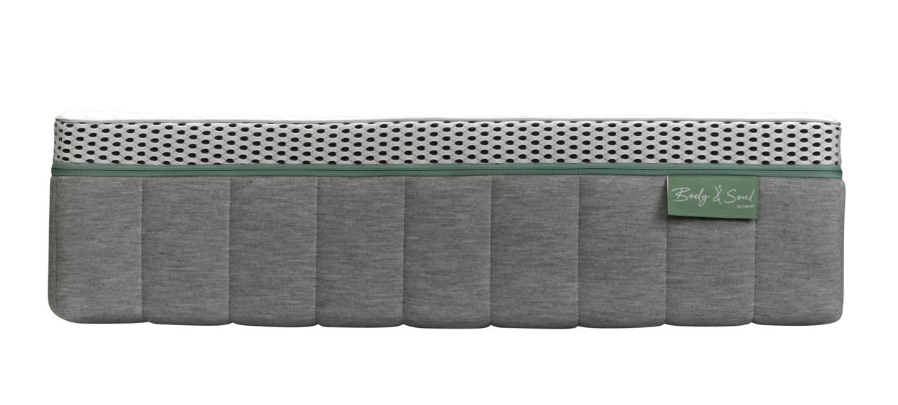 Seitenansicht einer grauen Matratze mit weißem, gepunktetem Oberteil und grünem Etikett.