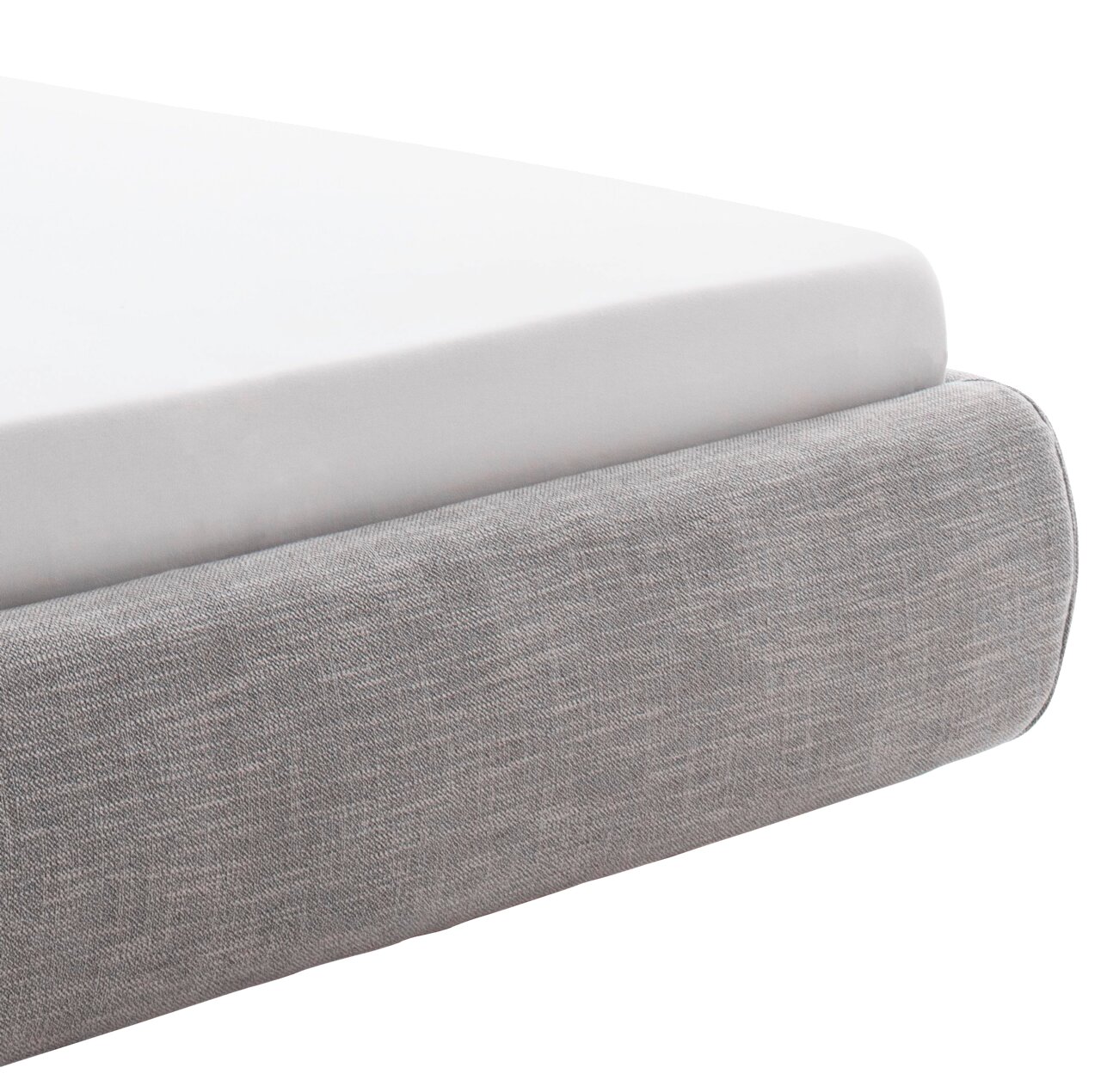 Nahaufnahme eines grauen Polsterbetts mit weißer Matratze, seitliche Perspektive.