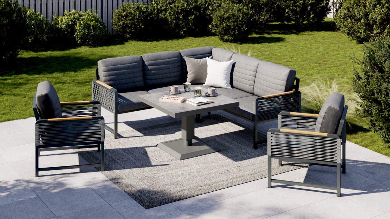 Moderne loungeset in de tuin met grijze bekleding, bestaande uit een hoekbank, een tafel en twee fauteuils, gefotografeerd vanuit vogelperspectief.