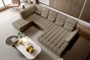 Beiges L-förmiges Ecksofa mit gesteppten Sitzflächen und verstellbaren Rückenlehnen in modernem Wohnzimmer, fotografiert aus schräger Vogelperspektive von oben.