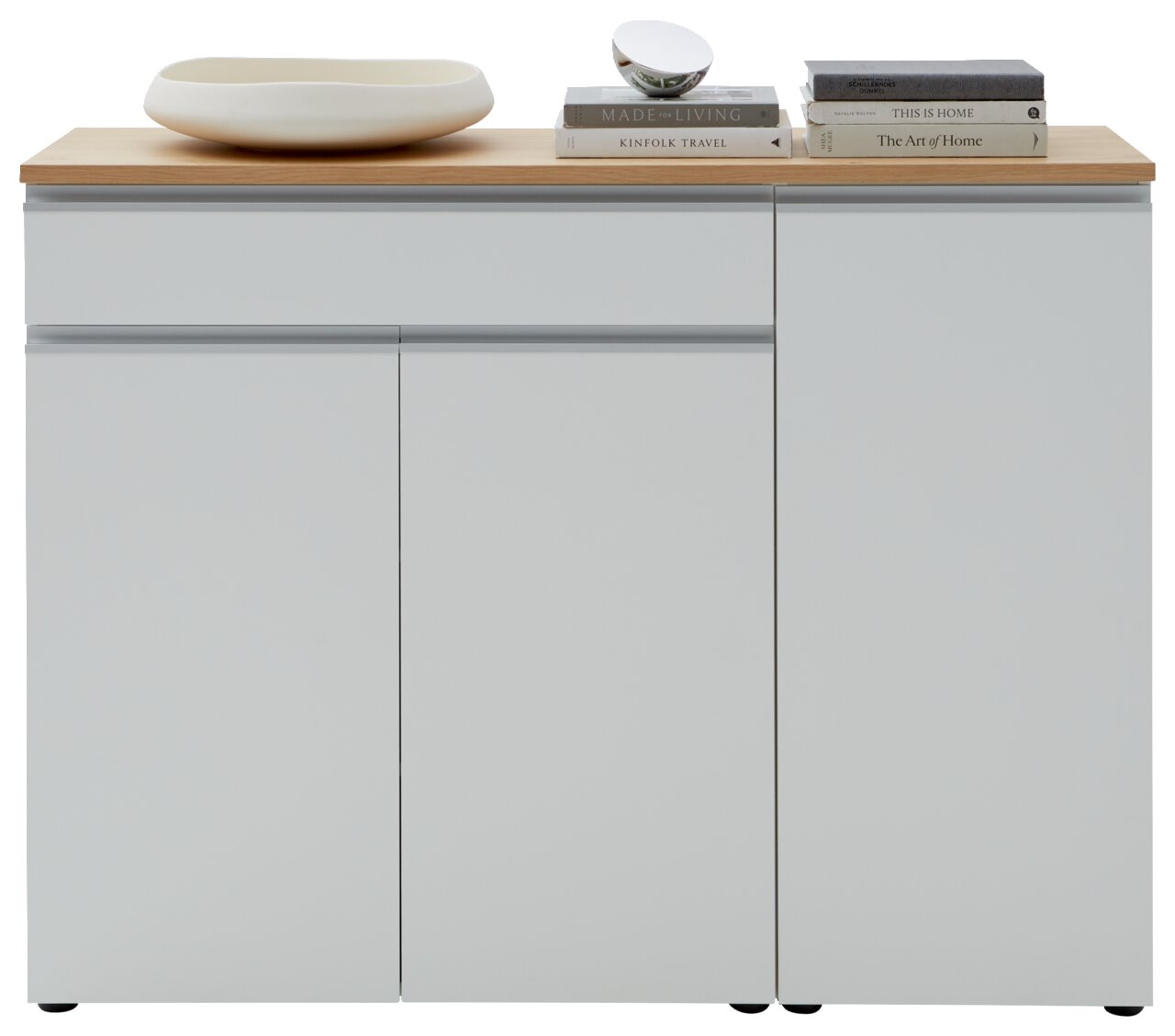Frontansicht einer modernen Kombi-Kommode mit weißer Oberfläche und Holzplatte, dekoriert mit Büchern und einer Schale.