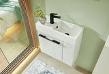 Modernes weißes Waschbecken mit schwarzem Wasserhahn und Unterschrank, von oben fotografiert, mit dekorativer Pflanze auf der Ablage.