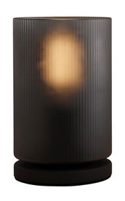 Zylindrische Tischleuchte COLOMERA mit geriffeltem, dunklem Glas und warmem Licht, seitliche Perspektive