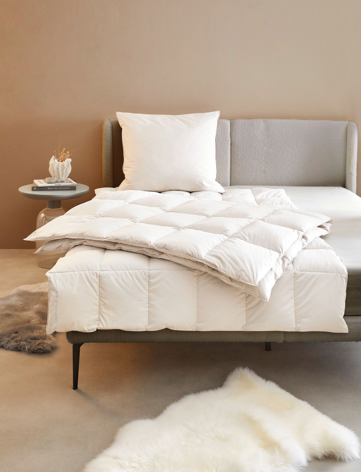 Bett mit weißer Bettdecke und Kissen, seitliche Perspektive