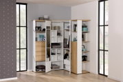 Eck-Kleiderschrank in heller Holzoptik mit offenen und geschlossenen Fächern, gefüllt mit verschiedenen Gegenständen, aus einer frontalen Perspektive fotografiert.
