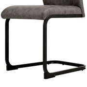 Moderne schommelstoel met grijze beklede zitting en zwart metalen frame, zijaanzicht