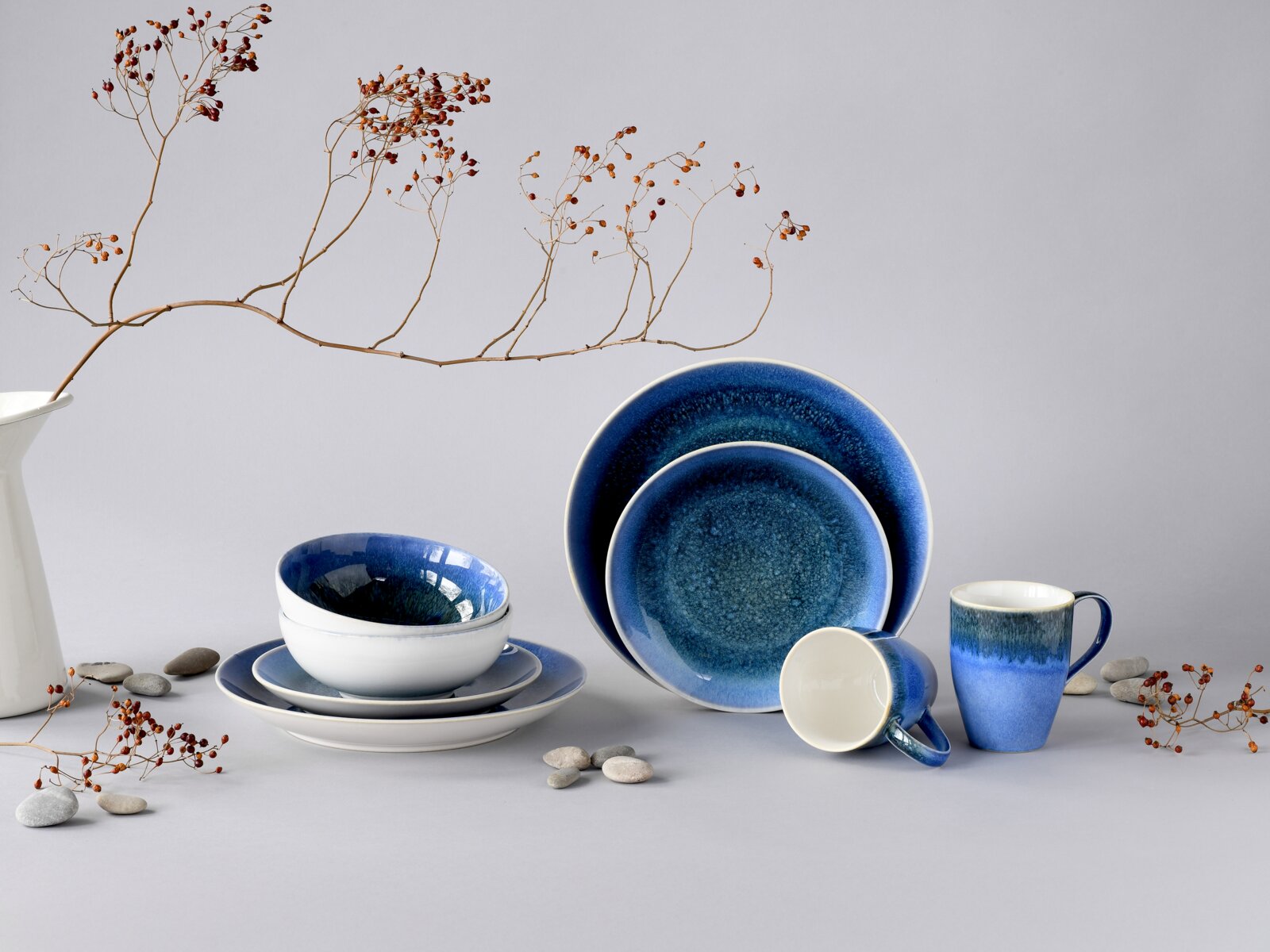 Creatable Kombiservice 8-tlg CALDERA Blau glasiertes Keramik-Geschirrset mit Tellern, Schalen und Bechern im Studio-Arrangement vor hellem Hintergrund, frontale leicht erhöhte Perspektive.