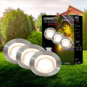 Erweiterungsset aus Edelstahl mit runden LED-Leuchten, präsentiert auf einer grünen Wiese mit Verpackung im Hintergrund, Perspektive von vorne.