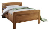 Komfortbett aus Holz in Frontalansicht mit Bettwäsche und grüner Decke