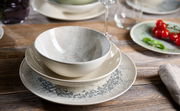 Suppenteller Cecina 21cm grau, von oben fotografiert, auf einem Holztisch mit weiteren Geschirrteilen und Dekoration.