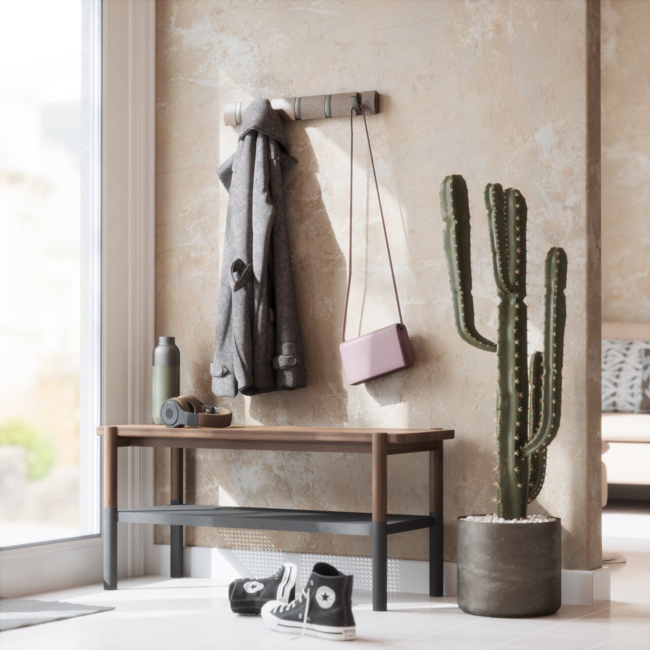 Wandgarderobe mit Jacke und Tasche, daneben ein Kaktus in einem modernen Eingangsbereich, Perspektive von vorne
