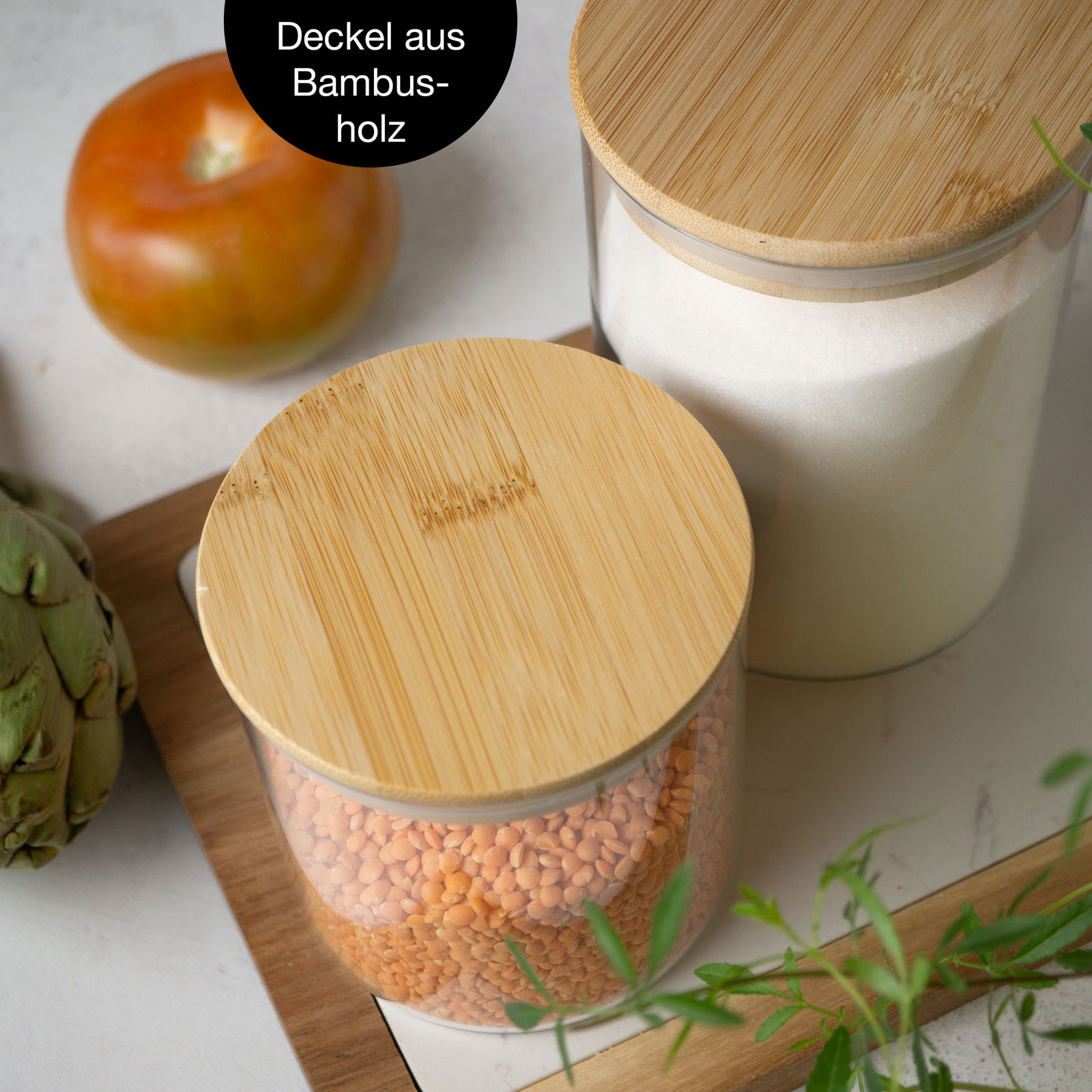 Vorratsglas mit Bambusdeckel, gefüllt mit roten Linsen, aus der Vogelperspektive fotografiert.