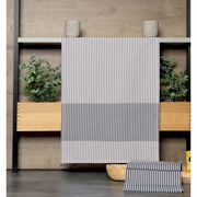 Gestreiftes Geschirrtuch in Grau und Weiß, hängend vor einem Holzregal mit Pflanzen, Vorderansicht