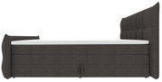 Donkergrijs, gestoffeerd boxspringbed met hoge, doorgestikte rugleuning en witte matrashoes, zijaanzicht (profiel) tegen een witte achtergrond