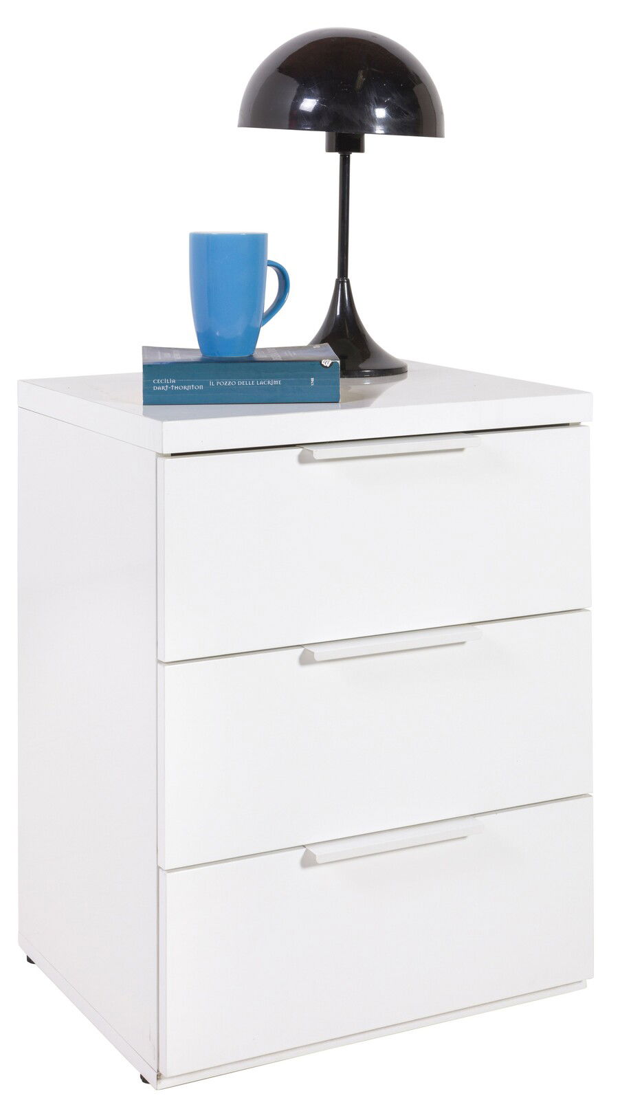 Weiße Nachtkonsole mit drei Schubladen, darauf eine schwarze Lampe und eine blaue Tasse, seitliche Perspektive.