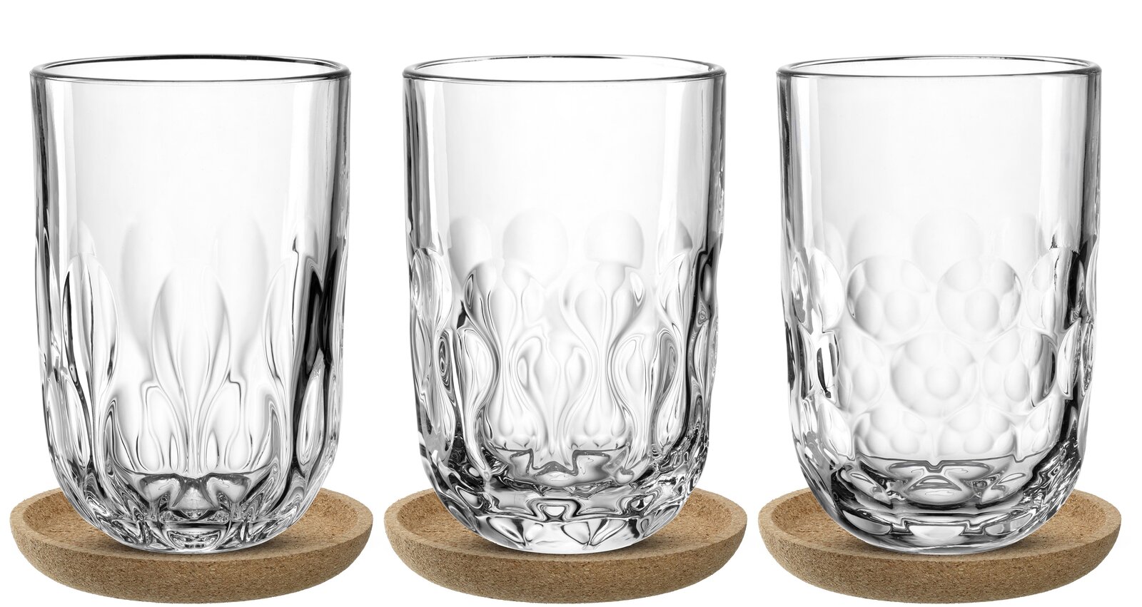 Drei Latte Macchiato-Gläser mit dekorativem Muster, auf runden Untersetzern, aus der Frontalperspektive fotografiert.