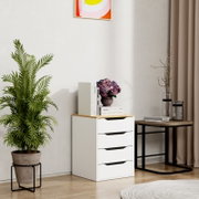 Modernes weißes Schubladen-Container/Kommode mit Holzplatte, dekoriert mit Büchern und violettem Blumenstrauß, im Wohnraum neben rundem Beistelltisch und Zimmerpflanze, Frontansicht leicht schräg von vorn