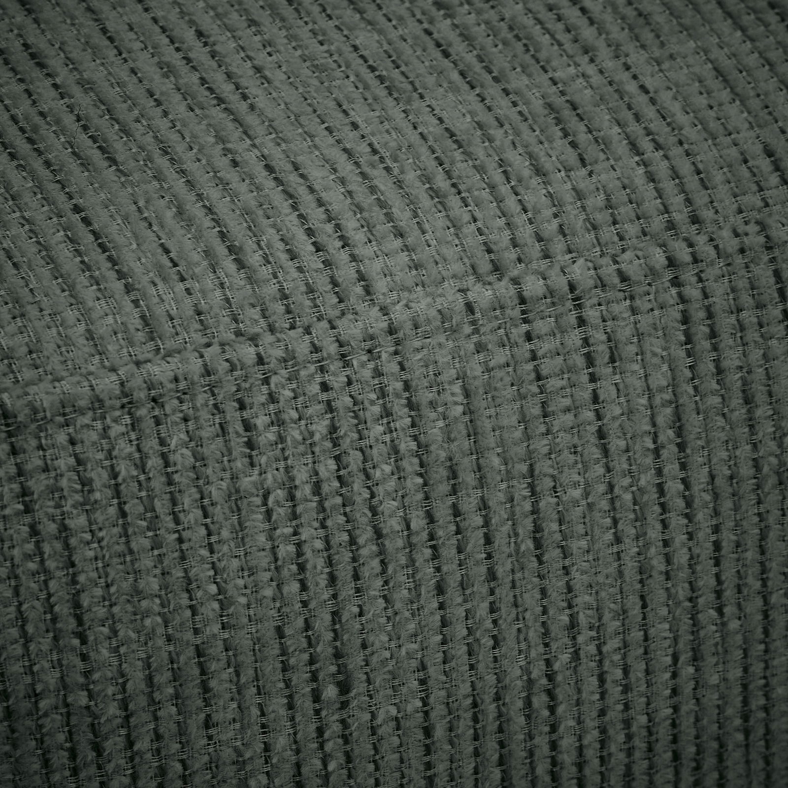 Nahaufnahme eines strukturierten, grauen Stoffes, der für eine Recamiere verwendet wird.