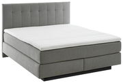 Graues Boxspringbett BX 180/200 mit gestepptem Kopfteil, seitliche Perspektive