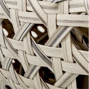 Close-up van een gevlochten patroon van lichte en donkere strepen, vanuit een zijdelingse hoek gefotografeerd.