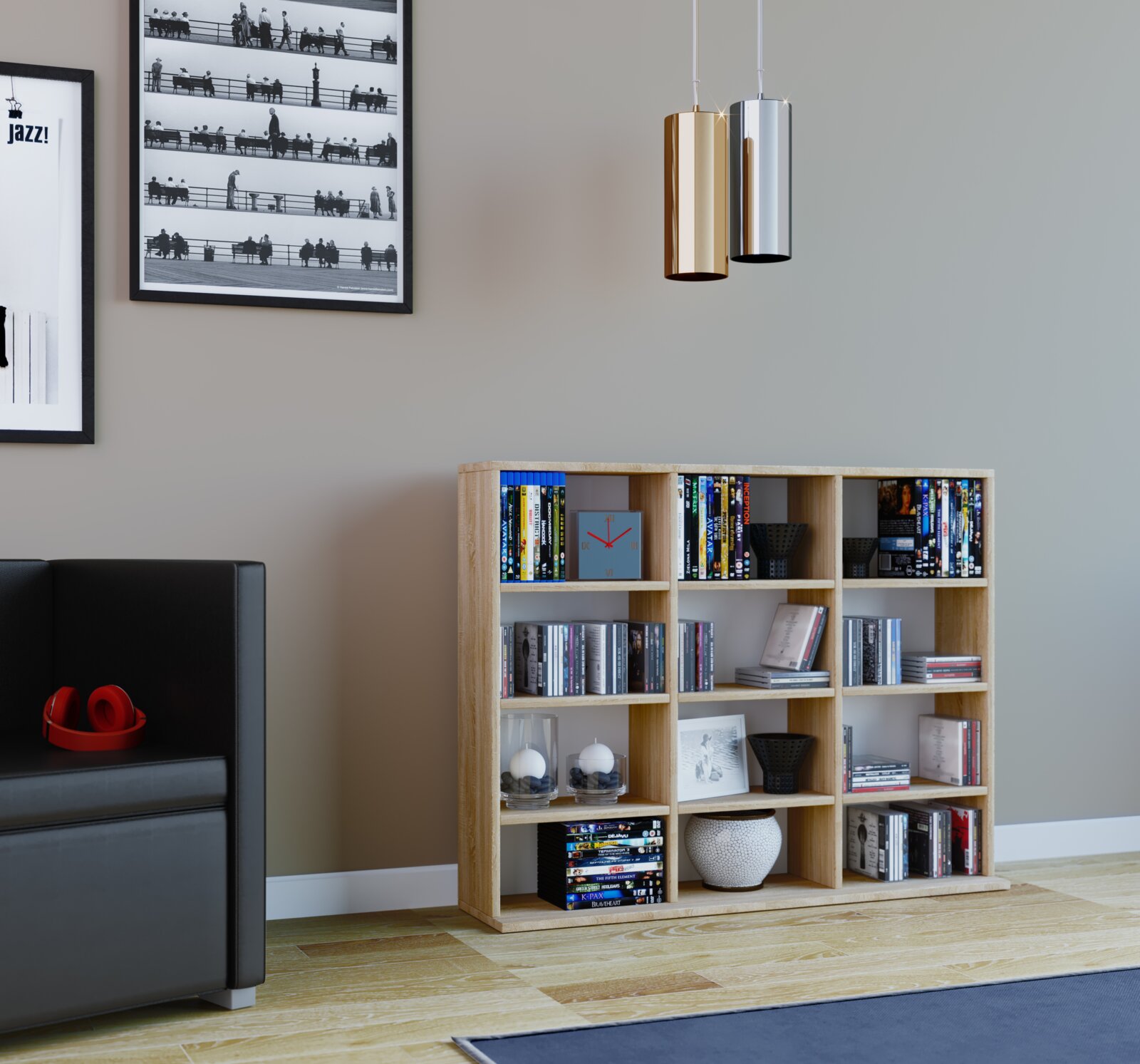 Modernes Wohnzimmer mit hellem Holzregal voller Bücher und DVDs sowie zwei zylindrischen Pendelleuchten in Gold und Silber Perspektive: frontale Ansicht auf Augenhöhe, leicht nach rechts versetzt.